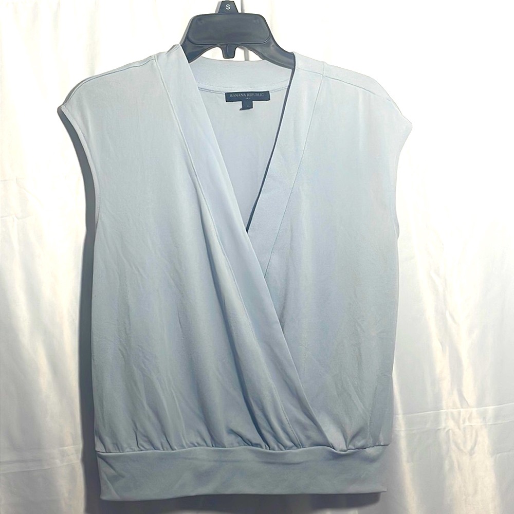Light blue Banana Republic wrap top with hook eye fastener. Lightweight fabric.